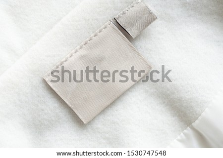 laundry care clothing label on fabric texture Royalty-Free Stock Photo #1530747548