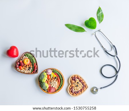 Organic  healthy  food,fruits,vegetables  in  wooden  bowl,stethoscope,red,green  heart  shape  and  leave  herb  on  white  background  for  creative  healthcare  and  ecology  concept Royalty-Free Stock Photo #1530755258