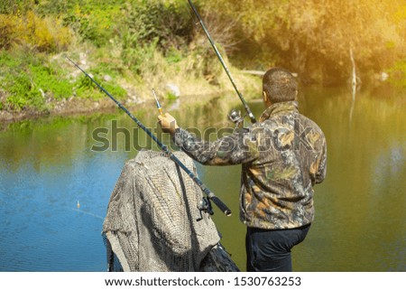 fishing hook in the hands of the fisherman and lake