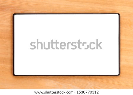 Mockup image of tablet pc with empty blank white screen on wooden table