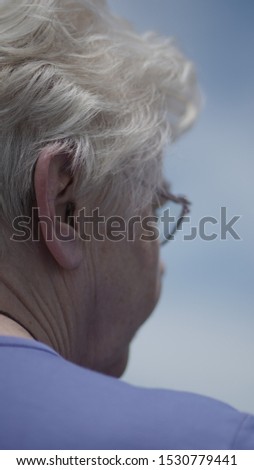 
healthy old woman looking at something and looking thoughtful