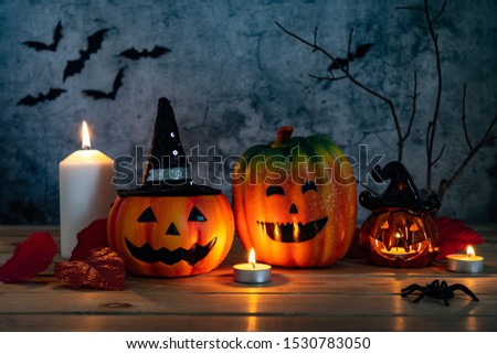 Accessories of decorations Happy Halloween day background concept.Jack O lantern pumpkin objects and light candle to party season with spider on brown & stone backdrop at home office desk studio.