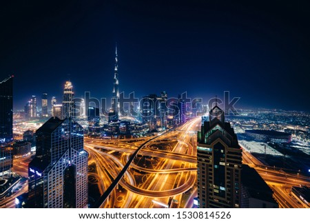 Long exposure photography of Dubai at night from the top of a building.