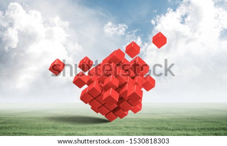 Abstract red cubes on green meadow. Digital technology and innovation solutions. New approach to business management. Nature landscape with green grass and blue sky. Mixed media with 3D object