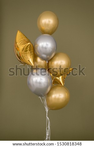 bunch of balloons silver with gold and stars