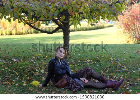 Asian young woman in casual style posing on autumn pine forest background.