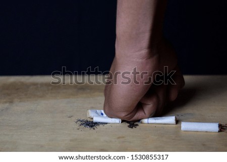 Man destroy cigarettes. Stop smoking or healthcare concept
