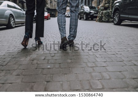 Cropped photo of unrecognized couple walking in the street