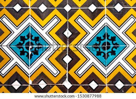 Colorful Portuguese traditional tiles Azulejos with blue, orange, brown and white geometrical pattern.