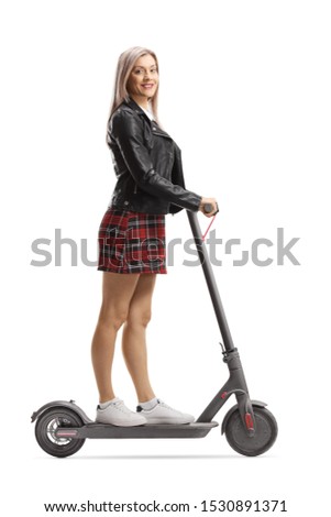 Beautiful young urban woman on an electric scooter isolated on white background