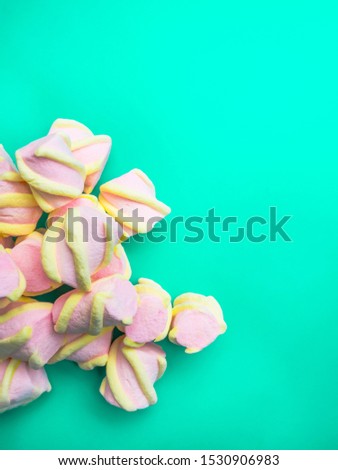 Lots of little marshmallows on trendy mint background,copy space