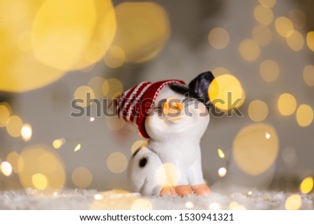 Decorative Christmas-themed figurines. Cute pig in a hat. Christmas tree decoration. Festive decor, warm bokeh lights