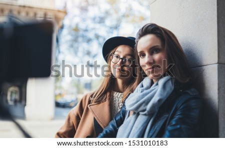 Girlfriends tourist taking photo portrait selfie together on smartphone mobile. Blogger hipster travels in europe city. Vacation holiday friendship concept. Travelers self on cellphone technology mock