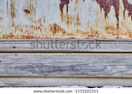 Old, rusty, oxidized,eroded metal and textured wooden board.