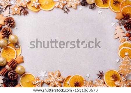 Christmas composition, New Year greeting card. Mockup with festive food decorations and gingerbread cookies on stone background. Copy space.
