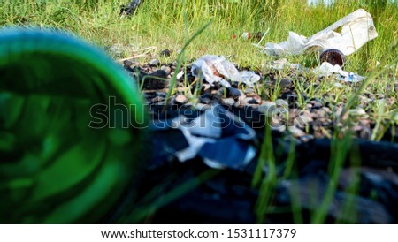 the left garbage on the nature after rest of the person, environmental pollution by glass and plastic