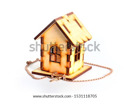 a wooden house and a Christian cross of gold, a charm of housing