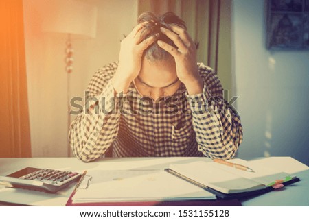 office syndrome concept; businessman sitting at office desk,  suffering from backache after working,man touching lower back with pained expression