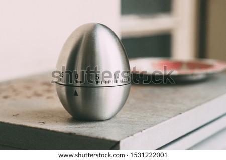 silver egg-shaped kitchen timer used for cooking and studying or working. Royalty-Free Stock Photo #1531222001