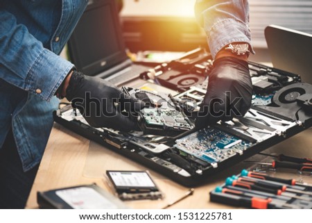 Technician reparing a broken computer. Computer service and repair concept.