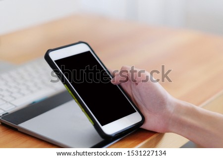 Female hand holding smartphone with stock market charts on smartphone screen
