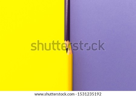 Minimal Flat Lay Top View Background Of Yellow And Purple Color Pencils For Drawing Isolated On Simple Backdrop. Conceptual Idea For Creative Workspace, School Stationery Equipment