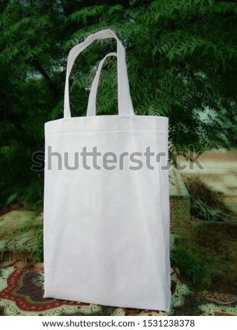 White eco Canvas Fabric Eco Bag Cloth Shopping Sack On Green Leaf Nature 