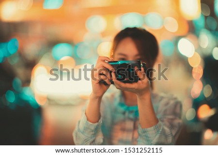 Closeup Woman holding mirrorless camera travel photo of photographer Making pictures in hipster style