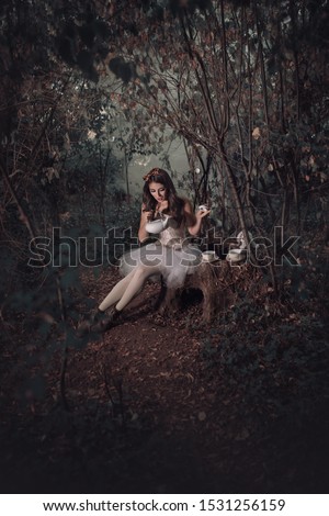 Beautiful girl in a fairy tale Alice in Wonderland