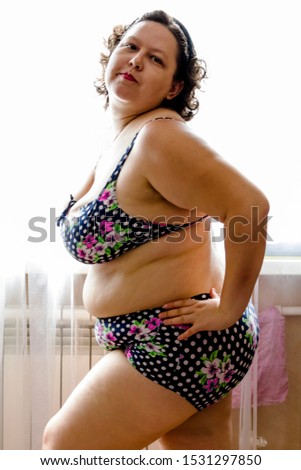 pictured in the photo young woman posing in a purple swimwear