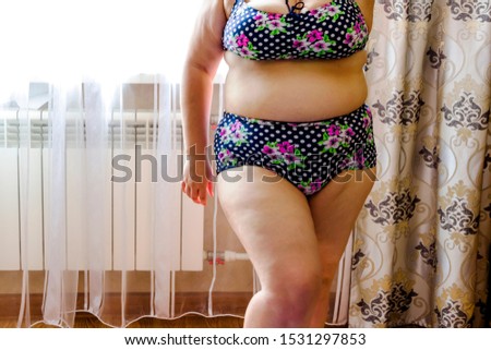 pictured in the photo young woman posing in a purple swimwear