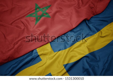 waving colorful flag of sweden and national flag of morocco. macro