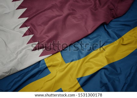 waving colorful flag of sweden and national flag of qatar. macro