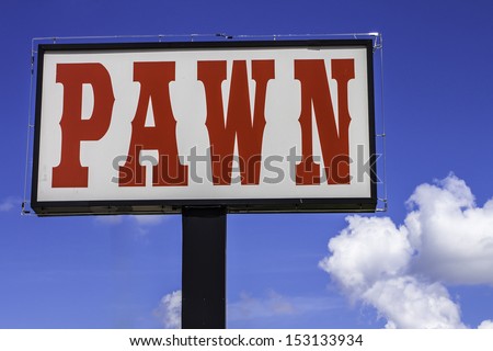 A large roadside sign for a pawn shop.