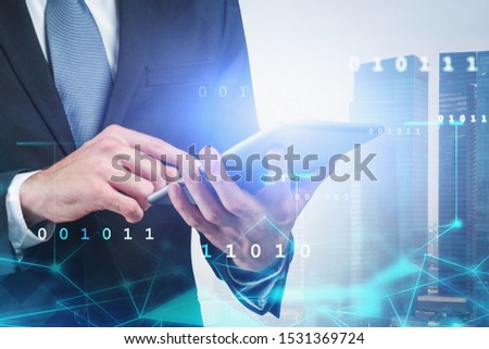 Unrecognizable businessman using tablet in city with double exposure of network interface and binary numbers. Concept of internet and communication. Toned image
