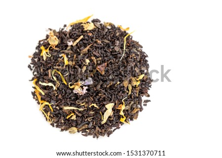 Overhead view of the heap of loose leaf black and green tea blend isolated on a white background