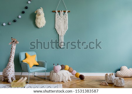 Stylish scandinavian kid room with toys, teddy bear, plush animal toys, mint armchair, umbrella, cotton balls. Modern interior with eucalyptus background walls, Design interior of childroom. Template 