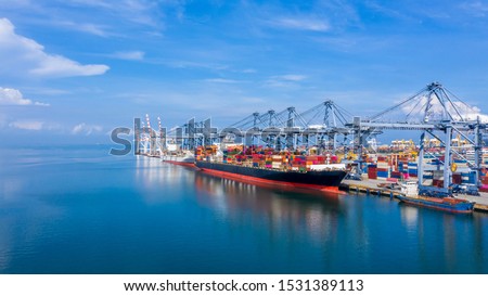 Container ship at industrial port in import export global business logistic and transportation, Container ship loading and unloading freight shipment, Aerial view container cargo boat freight ship. Royalty-Free Stock Photo #1531389113