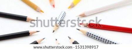 Letterbox view of short regular pencil stump surrounded by full length fellows on white background closeup Royalty-Free Stock Photo #1531398917