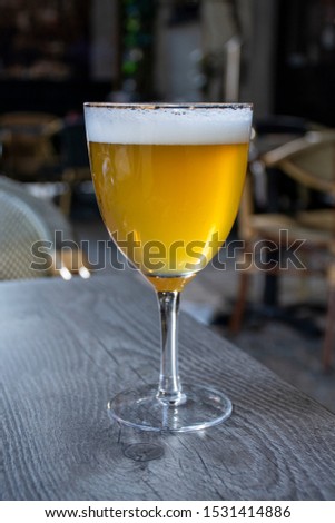 Famous Belgian beer served outside in small old cafe in special Belgian beer glass in sun lights Royalty-Free Stock Photo #1531414886