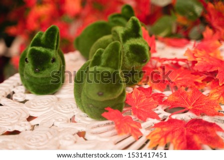 green grass decoration Rabbits on white retro table in the autumn countryside