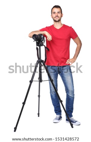 Young photographer with camera on tripod isolated on white background