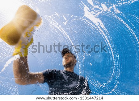 window cleaner with sponge cleaning glass window, Cleaning conept image Royalty-Free Stock Photo #1531447214
