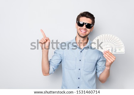 Photo of cheerful positive successful intelligent freelancer having earned lot of money with his brain pointing at most approachable way of enrichment isolated grey color background
