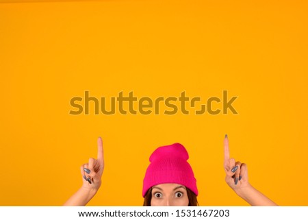 woman in hat shows hands place free advertisement banner isolated yellow background
