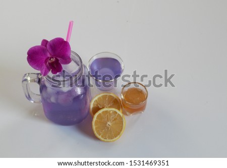 Healthy herbal beverage butterfly pea flower with lemon and honey bee juice on white background 