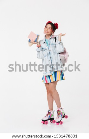 Image of cheerful young woman in retro roller skates holding books and copyspace isolated over white background