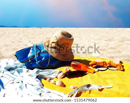 summer beach holiday  girl beachwear woman clothes fashion accessories hat sand sky blue  sunglasses seashell and cup of coffee on yellow towel on sand relaxing  travel tropical