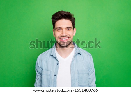 Close up photo of amazing macho guy revealing perfect white teeth wear casual denim shirt isolated over green color background