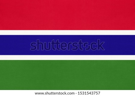 Republic of Gambia national fabric flag, textile background. Symbol of international african world country. State africa official sign.